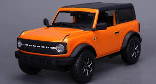 Miniature model of an orange-colored Bronco with an elegant look.