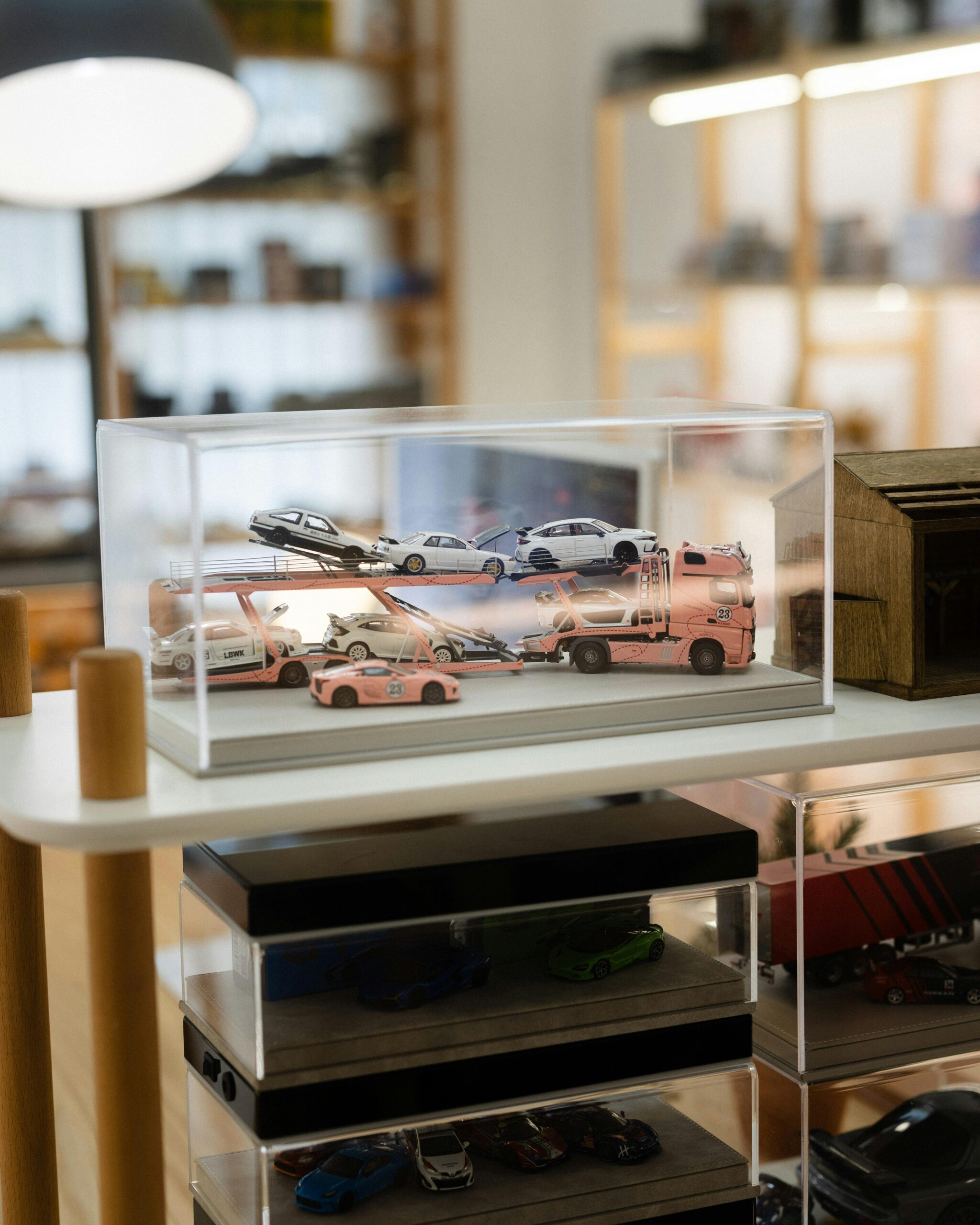 Miniature cars showcased in a stylish display within a Cambodian toy store.